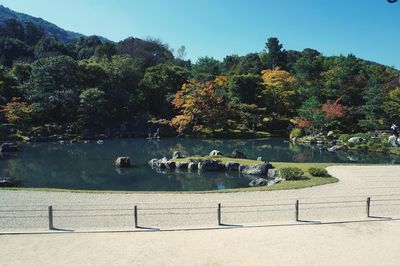 Scenic view of lake by trees against sky