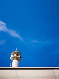 Low angle view of statue against blue sky