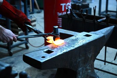 Cropped hand of man welding metal