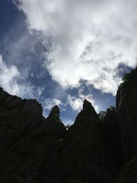 Low angle view of mountain against cloudy sky