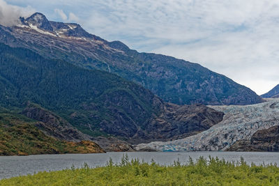 Scenic view of lake and mountains against sky