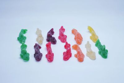 Close-up of multi colored candies against white background