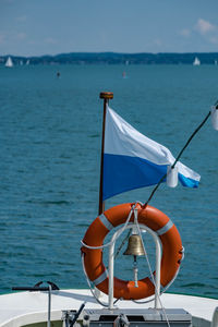 Sailboat moored on sea against sky