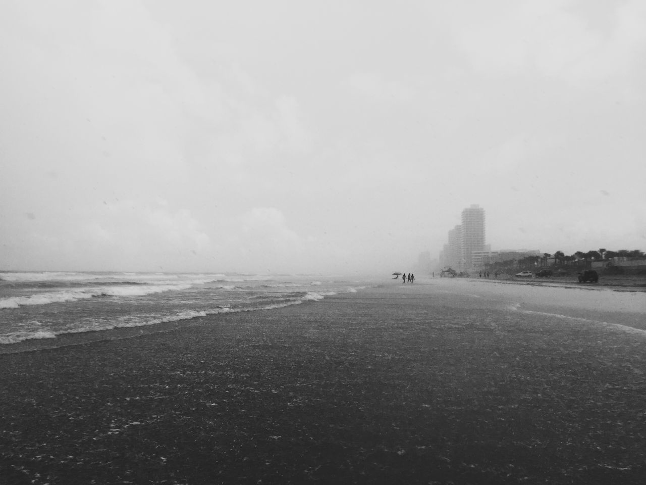 sea, water, beach, horizon over water, sky, copy space, shore, tranquil scene, weather, tranquility, nature, scenics, beauty in nature, clear sky, day, transportation, built structure, sand, overcast