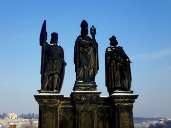 Low angle view of statues at on charles bridge against sky