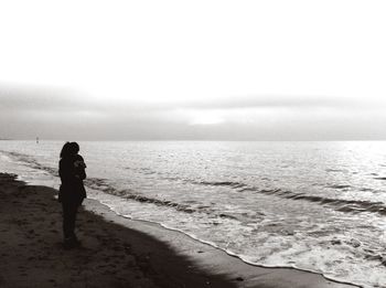 Rear view of man standing on beach