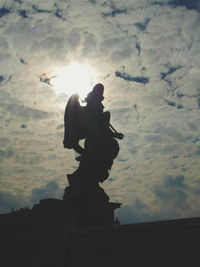 Low angle view of statue against cloudy sky