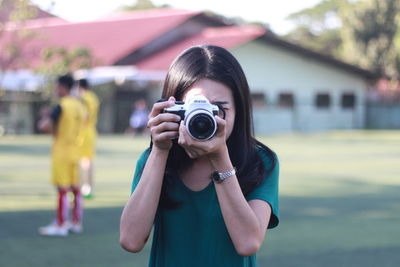 Portrait of teenage girl photographing