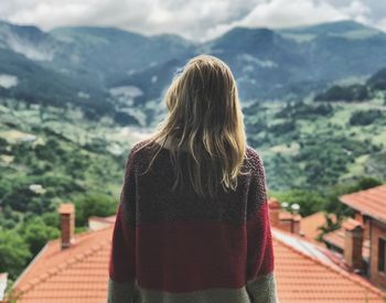 Rear view of woman looking at mountain range