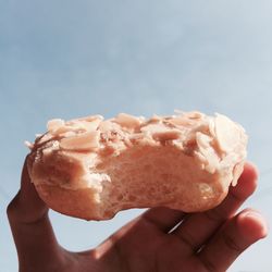 Close-up of hand holding donuts