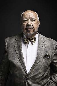 Portrait of senior man against black background