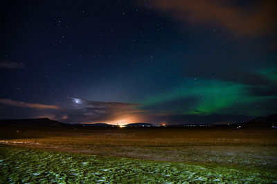 Scenic view of field against sky at night