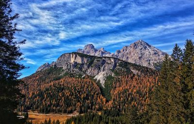 View of rocky mountain against cloudy sky
