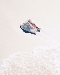 Close-up of ring on sand