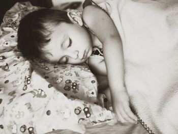 Close-up of boy sleeping on bed at home