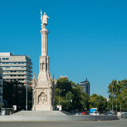 Statue of historic building against blue sky