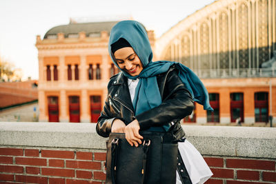 Full length of woman standing in city during winter