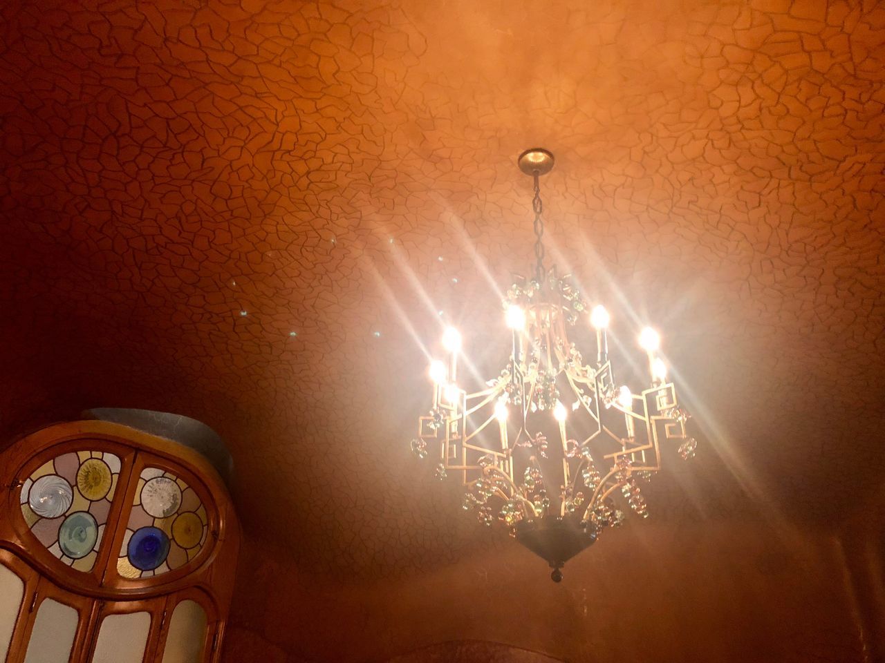 illuminated, lighting equipment, indoors, light, no people, electricity, electric light, chandelier, technology, hanging, light bulb, light - natural phenomenon, low angle view, ceiling, electric lamp, glowing, decoration, pendant light, close-up, wall - building feature, luxury, light fixture, ornate, electrical equipment