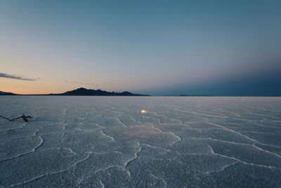 Bonneville salt flats against blue sky during sunset