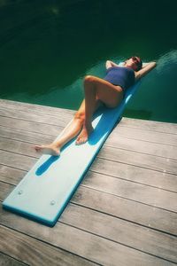 High angle view of woman lying down in swimming pool