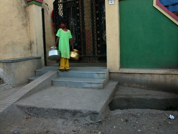Woman standing in front of built structure