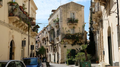 Street amidst buildings in city against sky