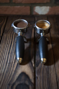 Photo of coffee, pre and post grinded on wooden table