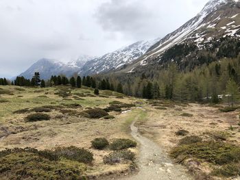 Scenic view of mountains against cloudy sky