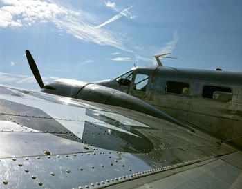 Low angle view of vintage airplane against sky