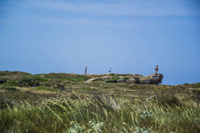 People on field against sky