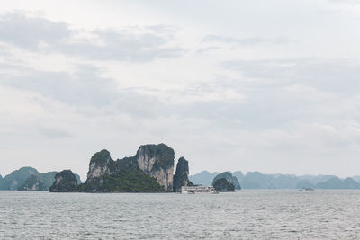 Scenic view of sea and mountains against sky