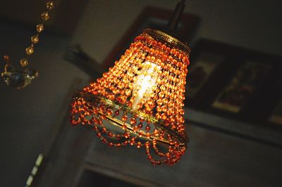 Low angle view of lit lamp post at night