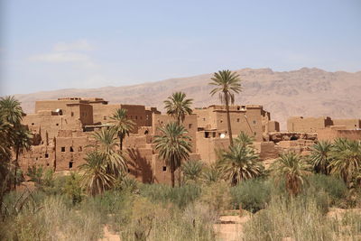 Old town on desert against sky