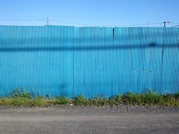 Metal fence against blue sky