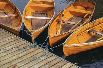 Several wooden boats tied up on a pier by the cam river in cambridge, england.