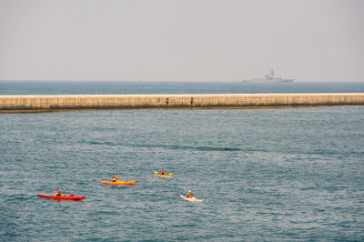 High angle view of people kayaking on sea