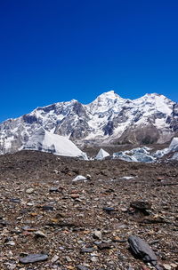 Scenic view of snowcapped mountains against clear blue sky