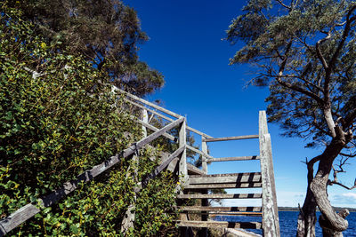 Low angle view of staircase against clear blue sky