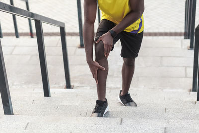 Low section of man standing on footpath