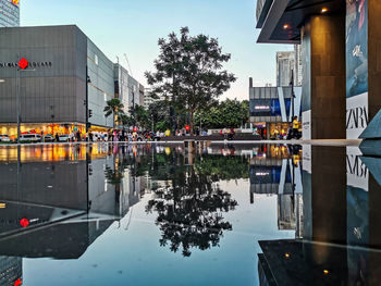 Reflection of building in puddle on street