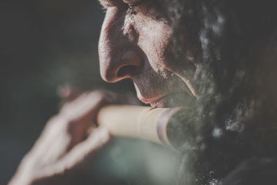 Close-up of mature man playing flute