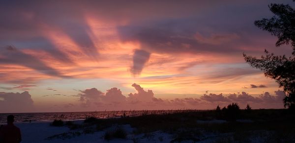 Scenic view of dramatic sky over sea during sunset