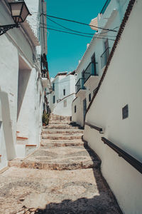 Staircase leading towards building against sky