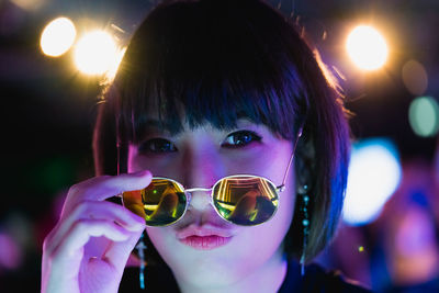 Portrait of boy holding sunglasses