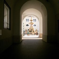 Woman in corridor background water fountain 