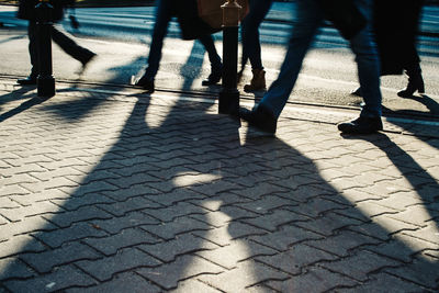 Low section of people walking on footpath