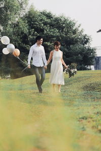 Couple walking on field