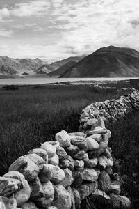 Rocks on field against sky