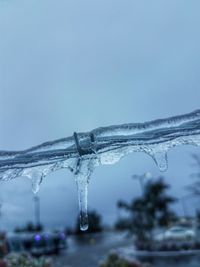 Close-up of water drop against sky