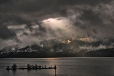 Scenic view of sea against storm clouds